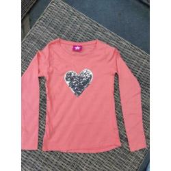 Longsleeve oranje met pailletten mt 128/134
